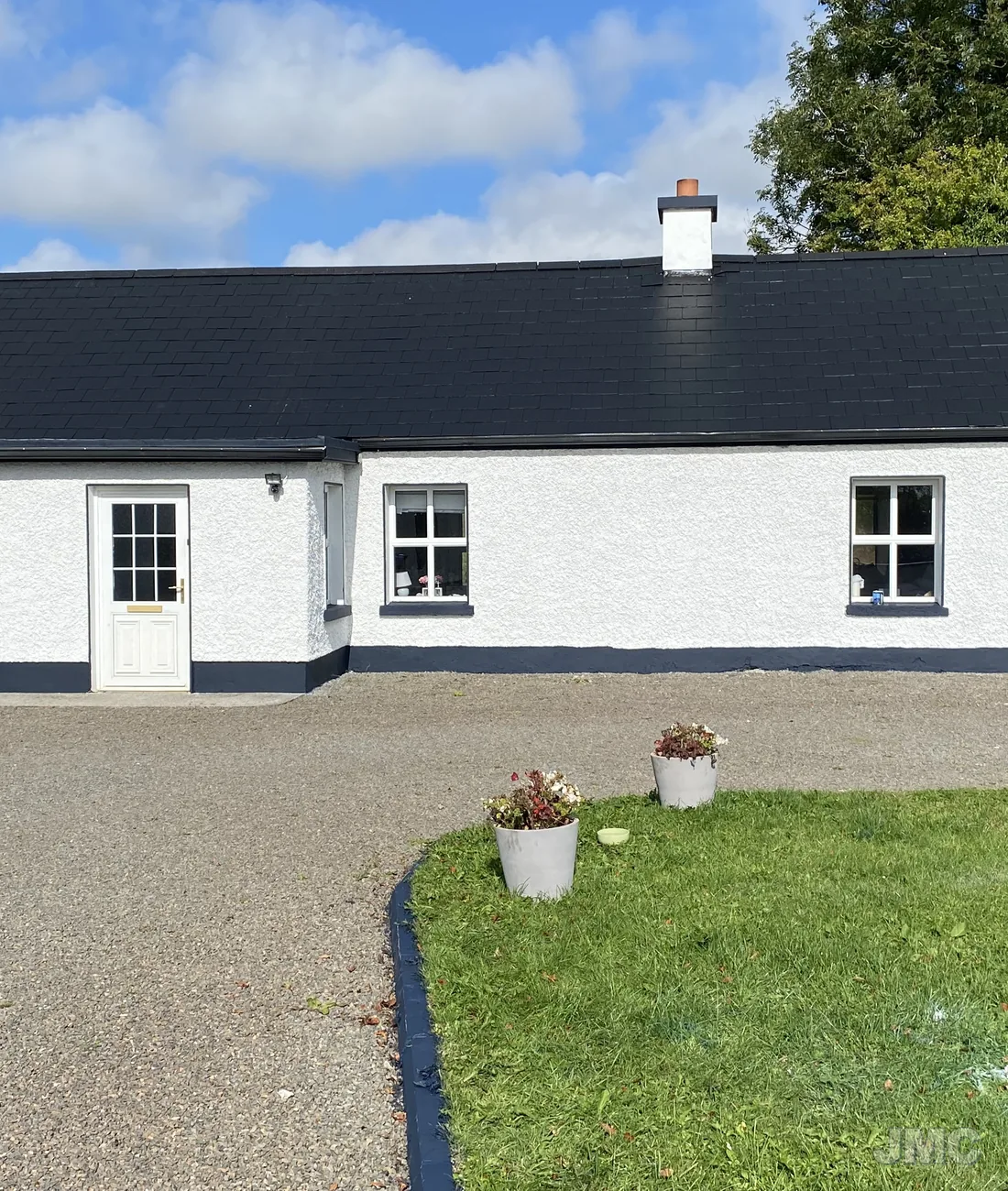 A cottage washed, roof coated and walls repainted
