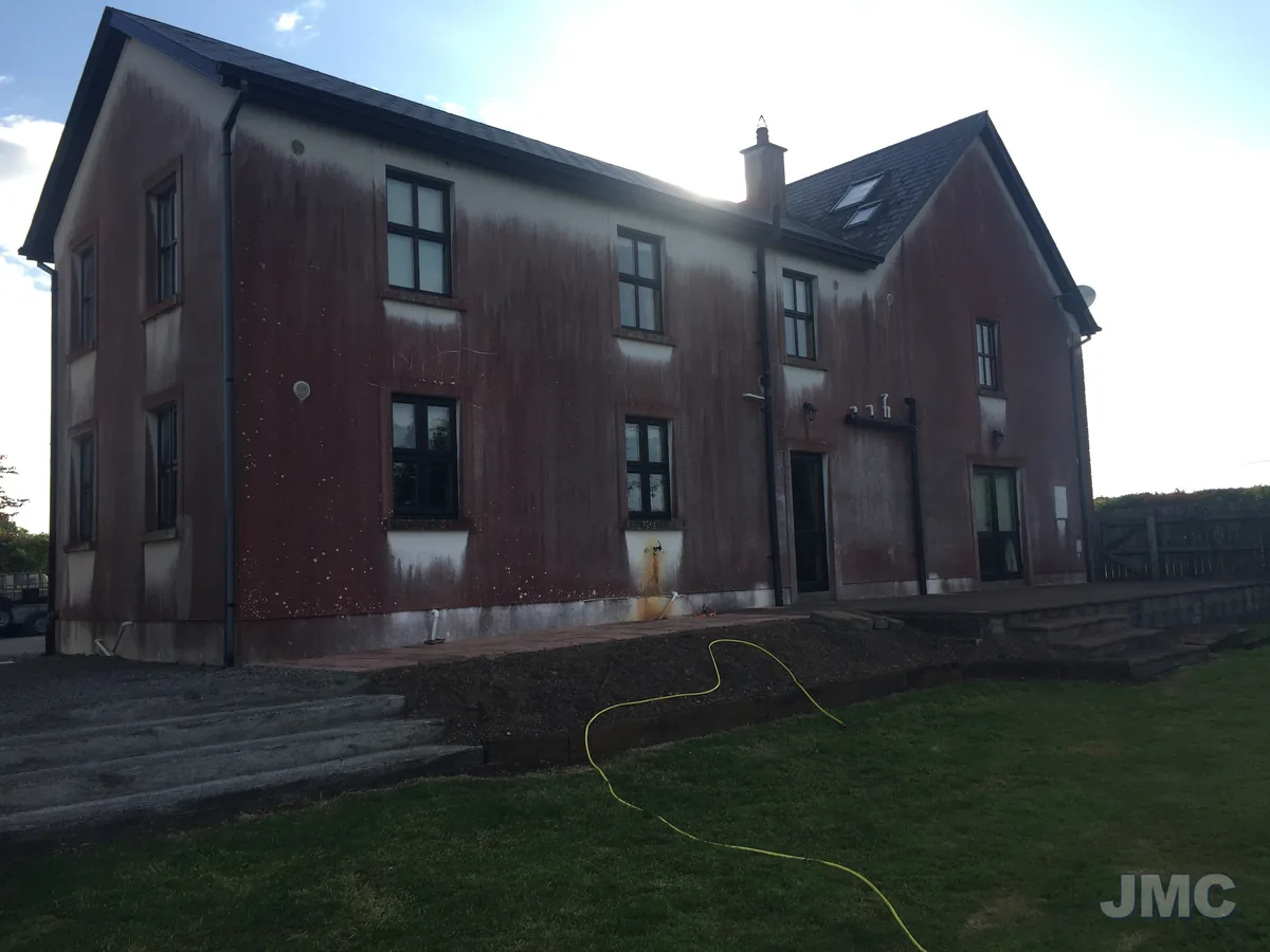 Before: Red algae softwashed off a two-storey house