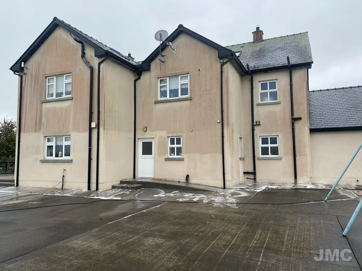 Before: Two-storey house, walls softwashed