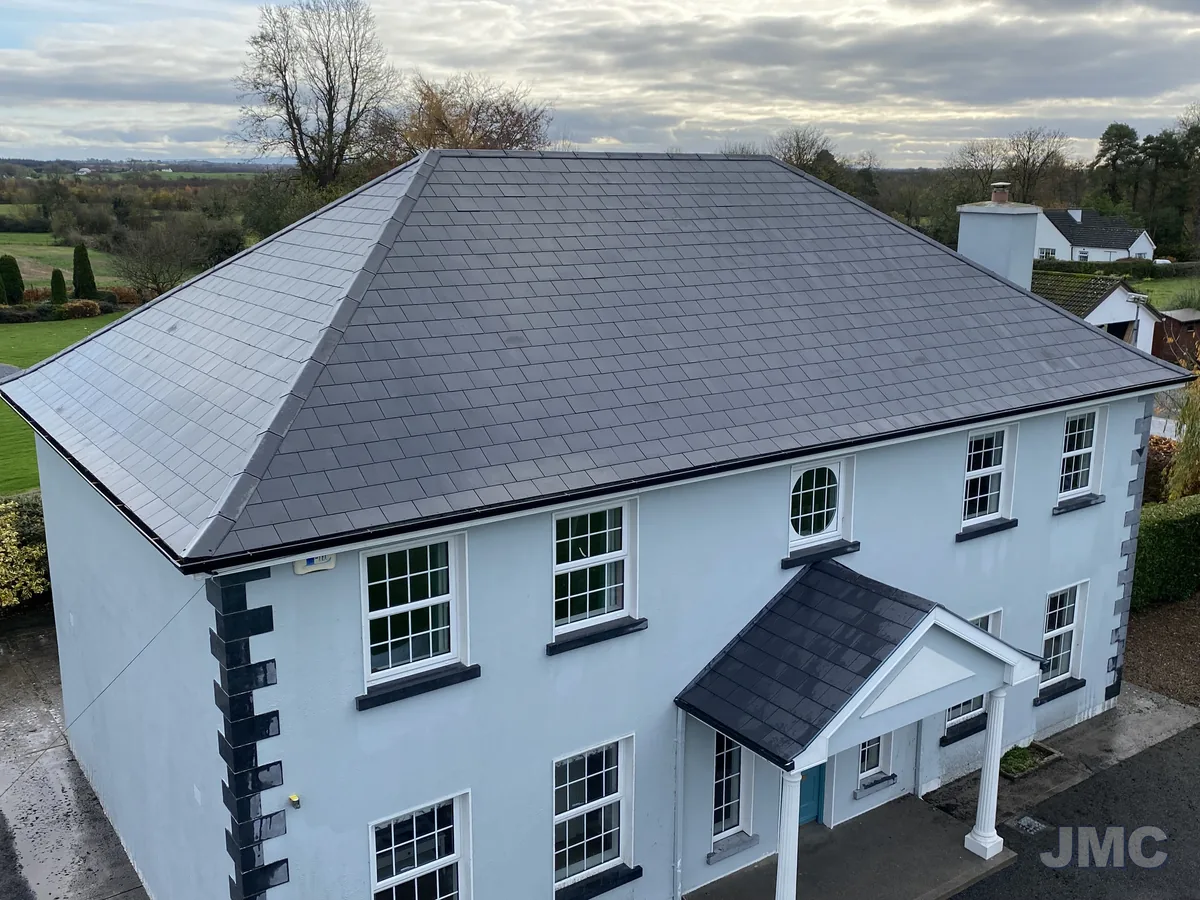 After: Hipped slate roof, moss and lichen removed