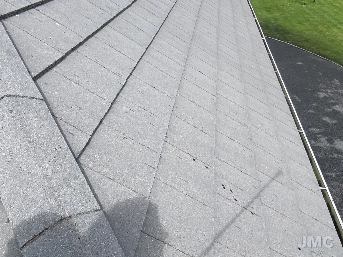After: Roof edge, moss removed from every course
