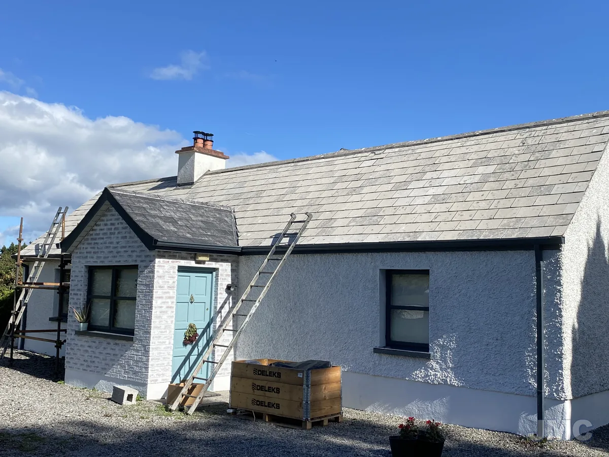 Before: Cottage roof coated black, walls washed