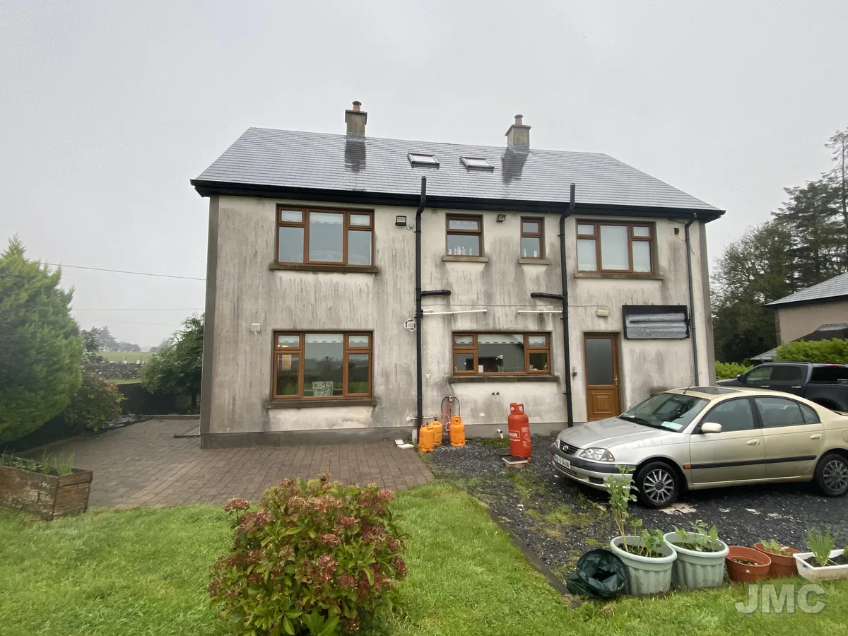 Before: House front, green and black staining lifted