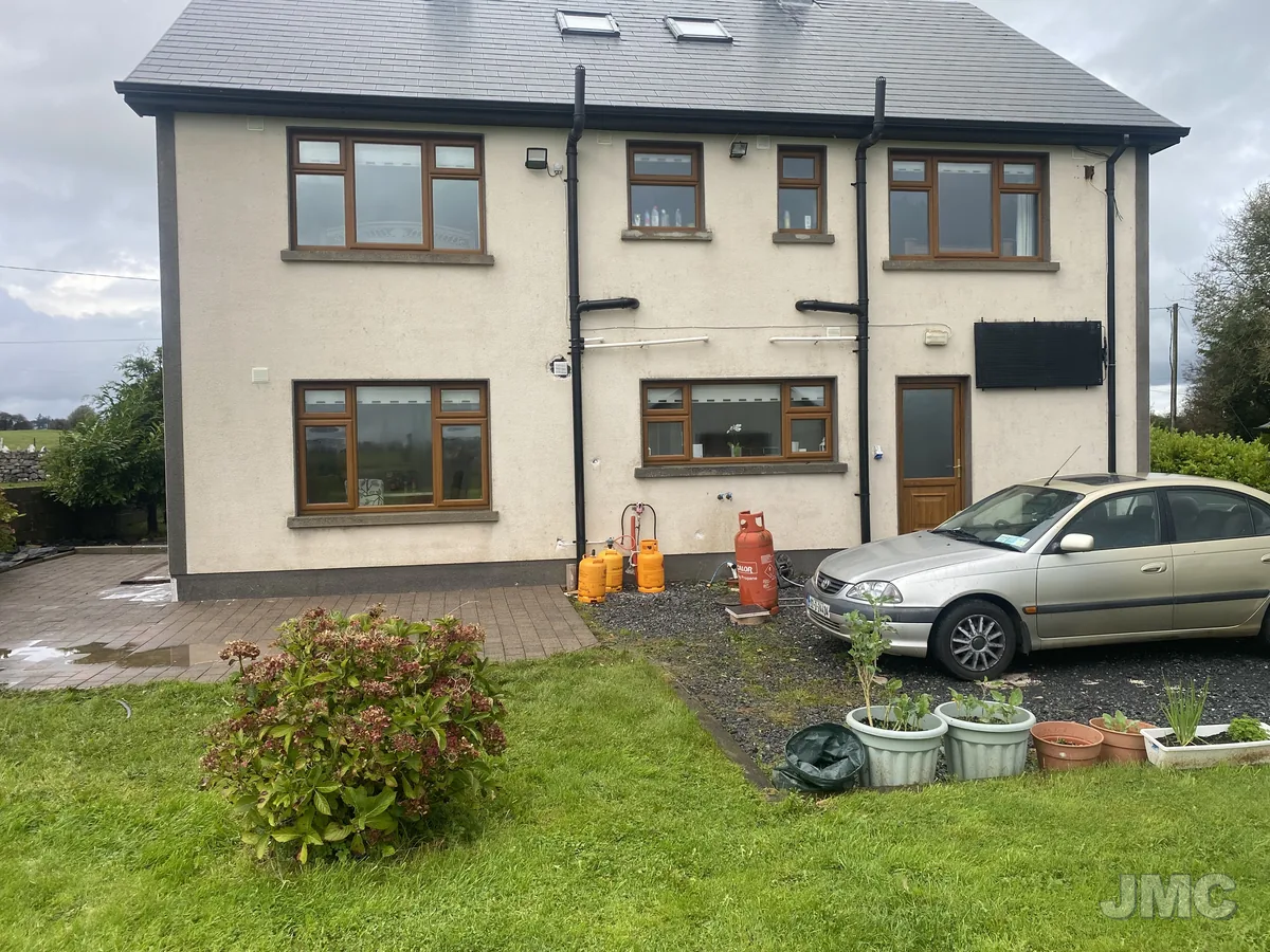 After: House front, green and black staining lifted