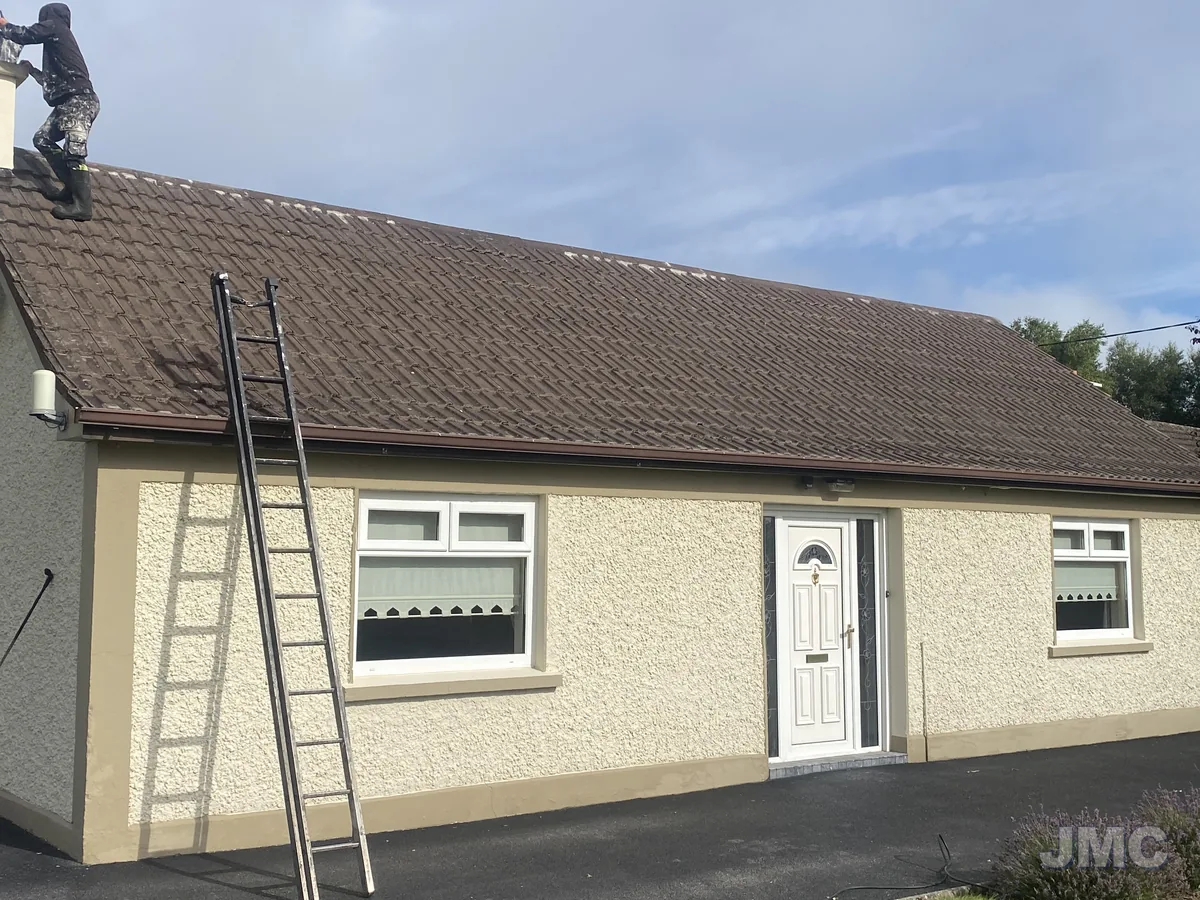 Before: Bungalow walls and roof, cleaned and coated