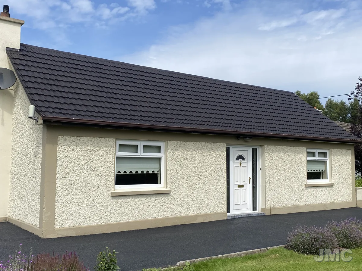 After: Bungalow walls and roof, cleaned and coated