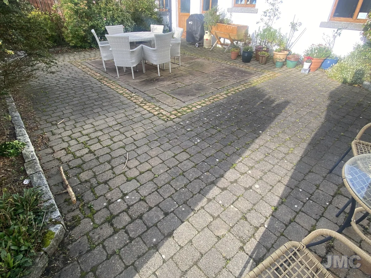 Before: Cobble courtyard, moss and staining removed
