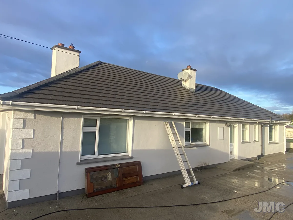 After: House front washed, gutters cleared